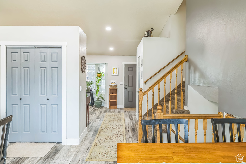 Entryway with light wood-style flooring, baseboards, recessed lighting, and stairway