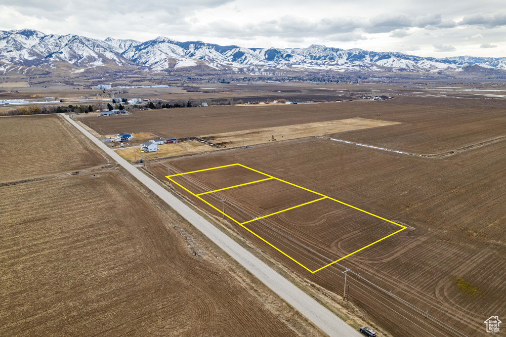 Aerial view of sparsely populated area featuring property parcel outlined and mountains