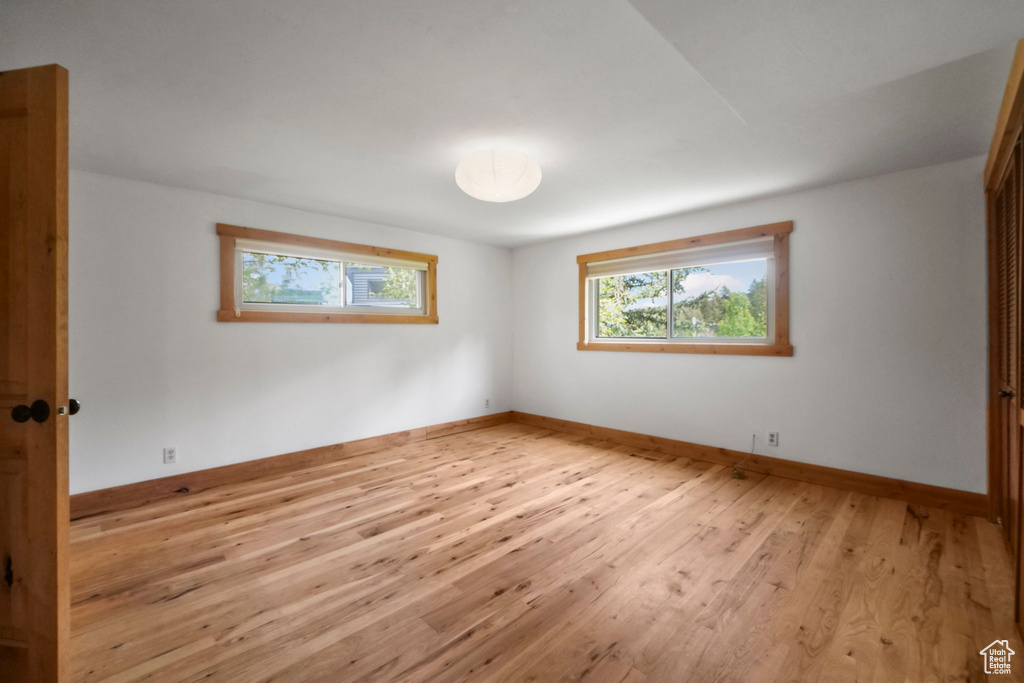 Empty room with light wood-style floors and baseboards