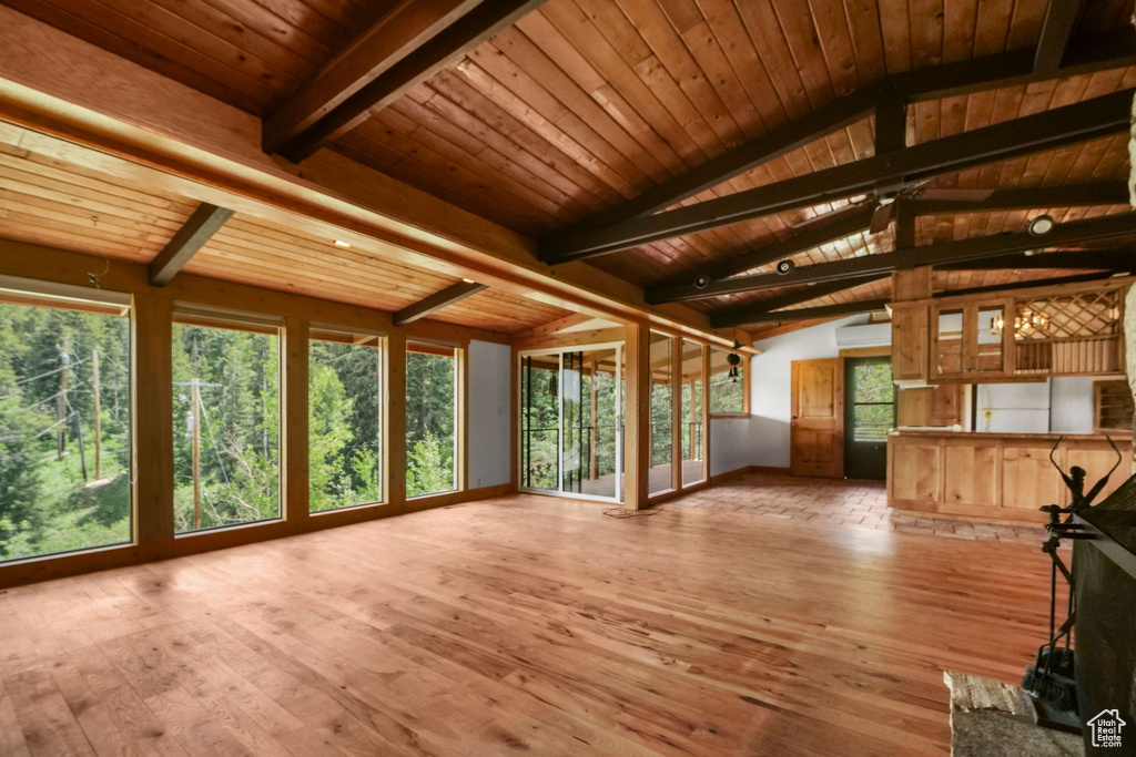 Unfurnished living room featuring wood-type flooring and wood ceiling