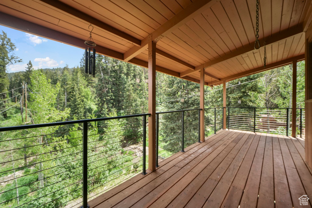 Wooden deck featuring a forest view