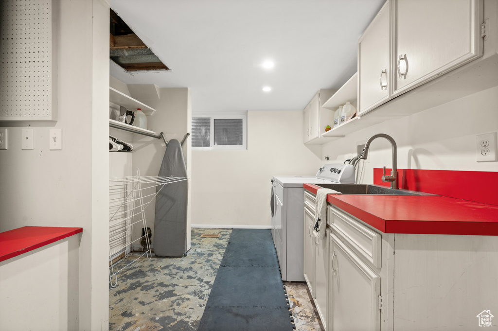 Laundry room with cabinet space, washer and dryer, and recessed lighting