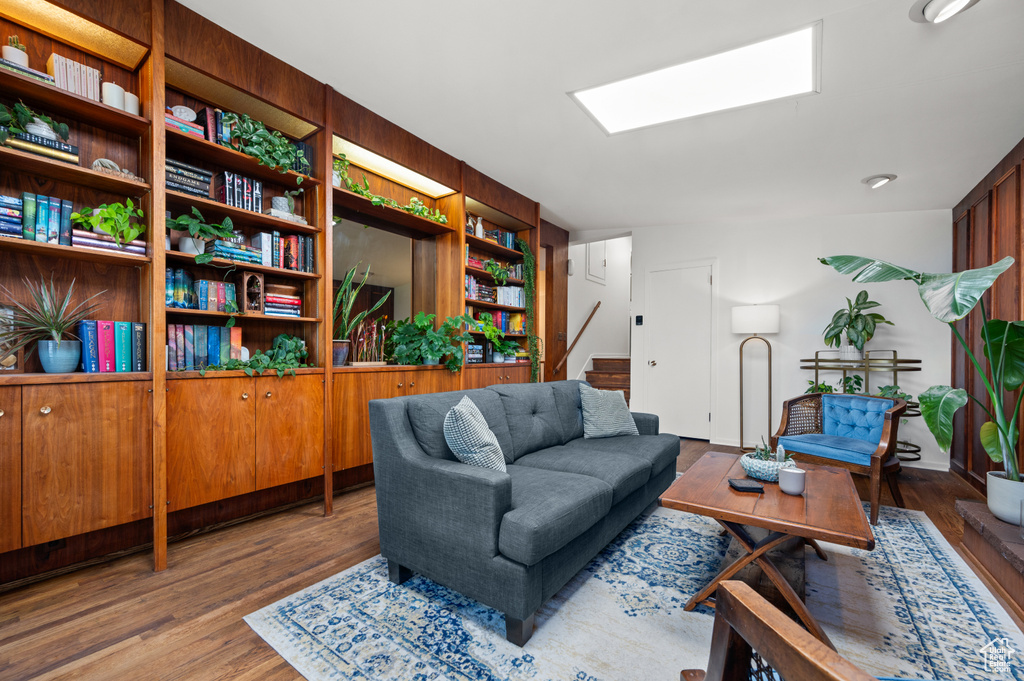Living area with stairway, wood finished floors, and a skylight