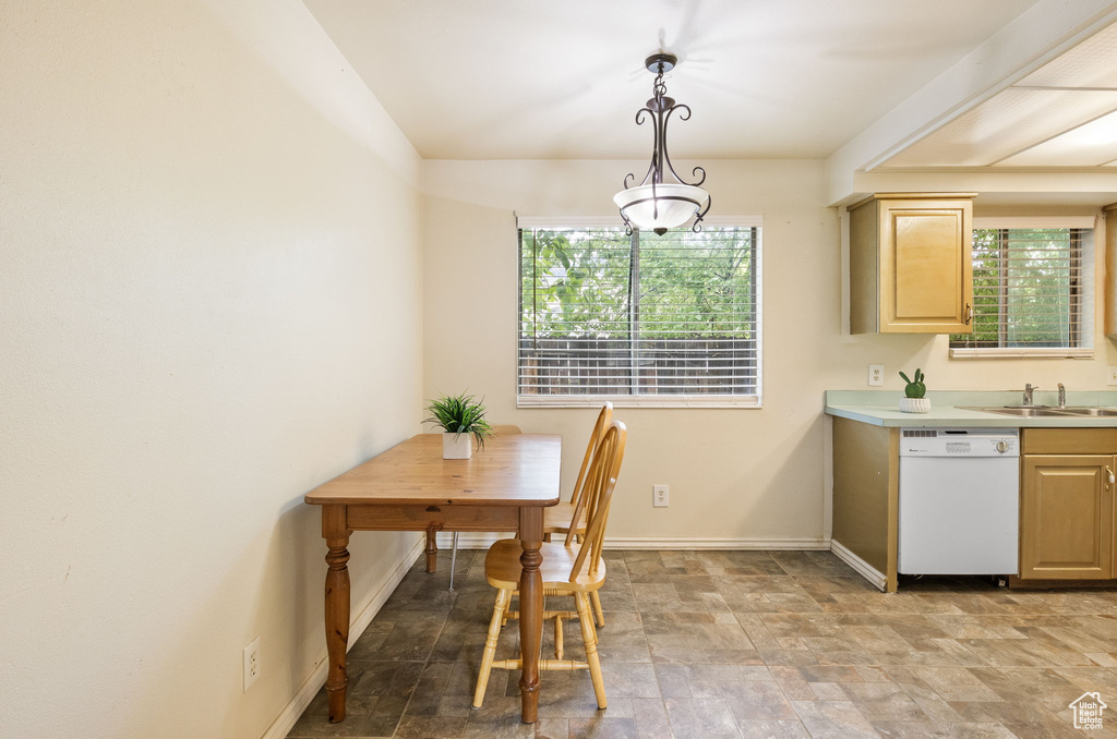 Dining room featuring baseboards and stone finish floors
