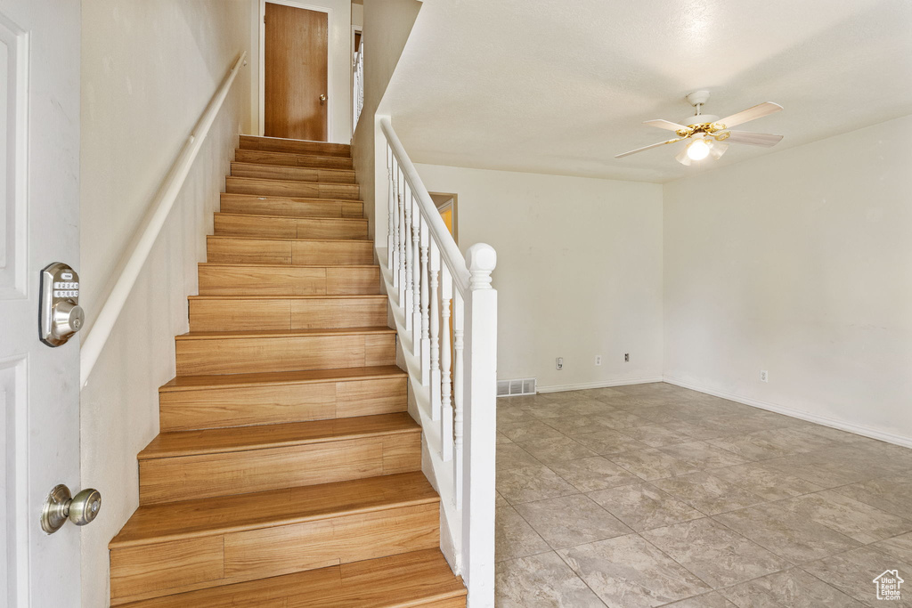 Stairway with a ceiling fan