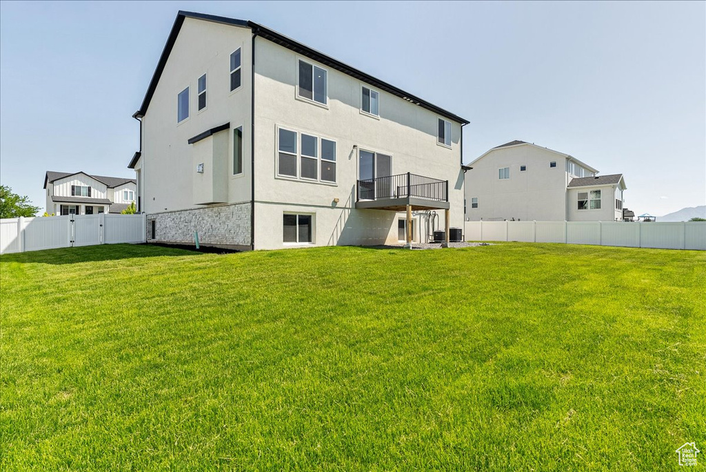 Rear view of property featuring stucco siding and central air condition unit