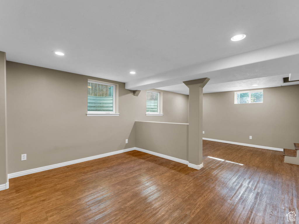 Basement with baseboards, wood finished floors, and recessed lighting