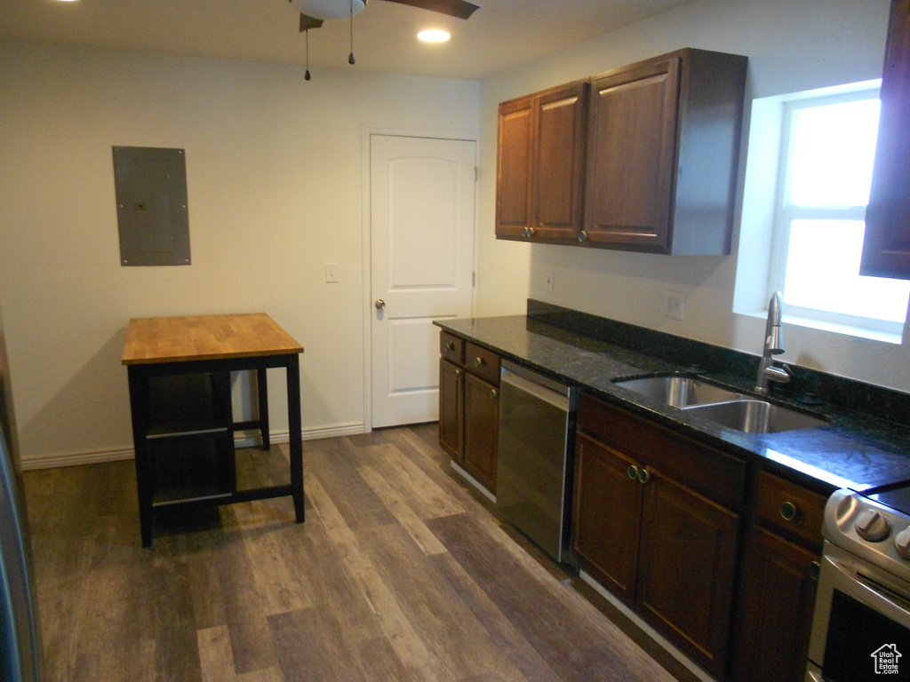 Kitchen with electric panel, stainless steel dishwasher, a sink, dark wood-type flooring, and ceiling fan