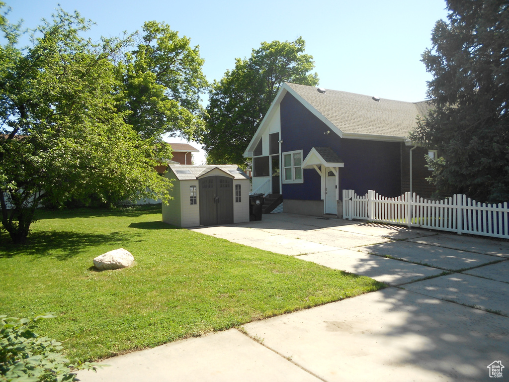 View of side of home featuring roof with shingles