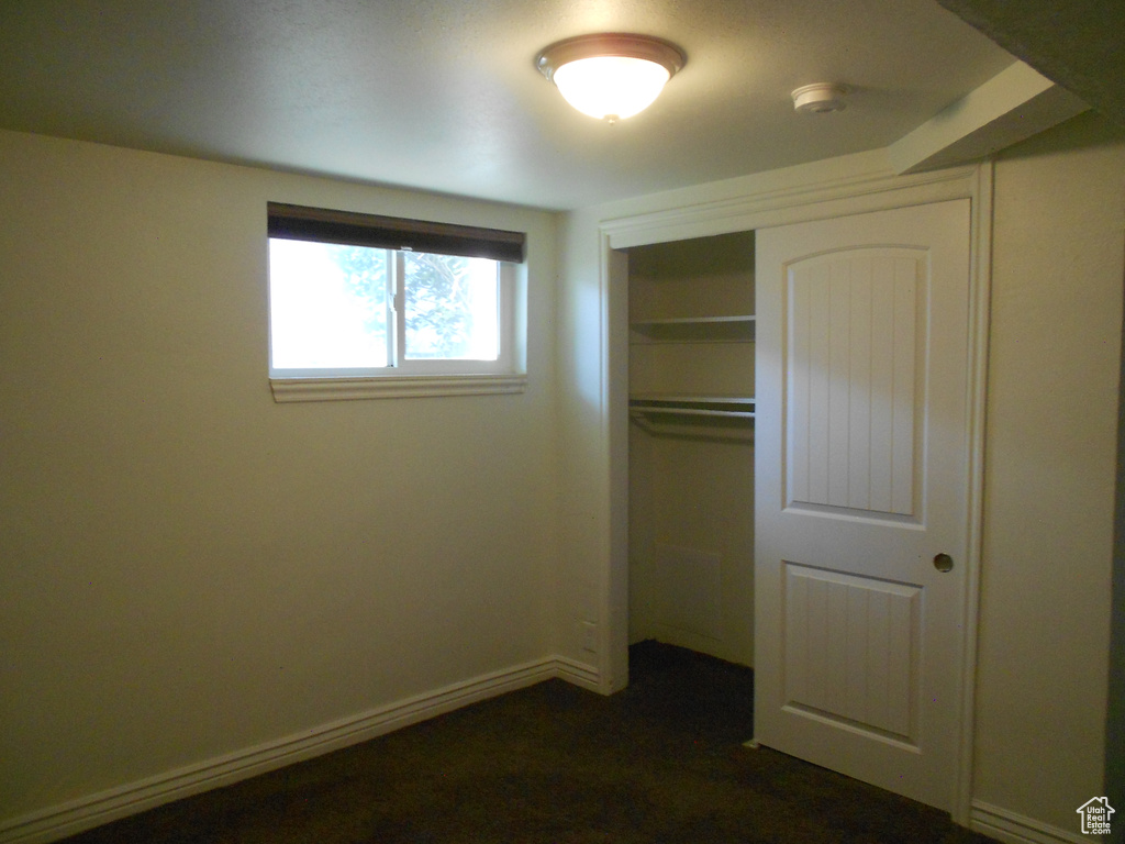 Unfurnished bedroom featuring a closet and baseboards