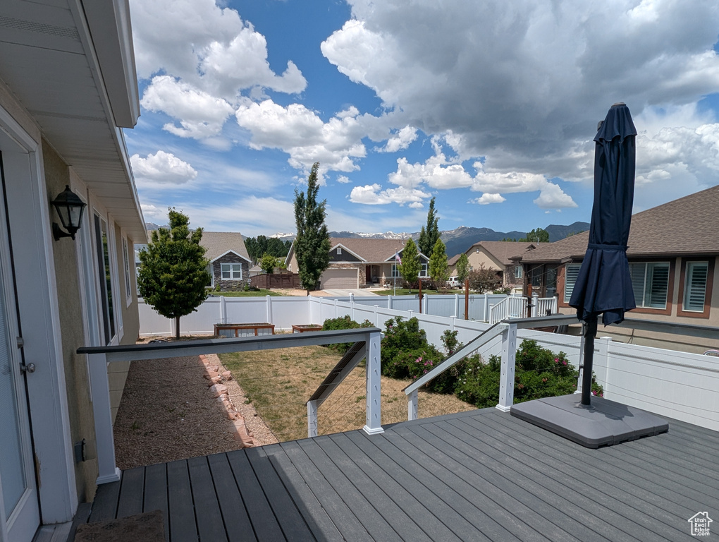 Wooden deck with a residential view and a mountain view