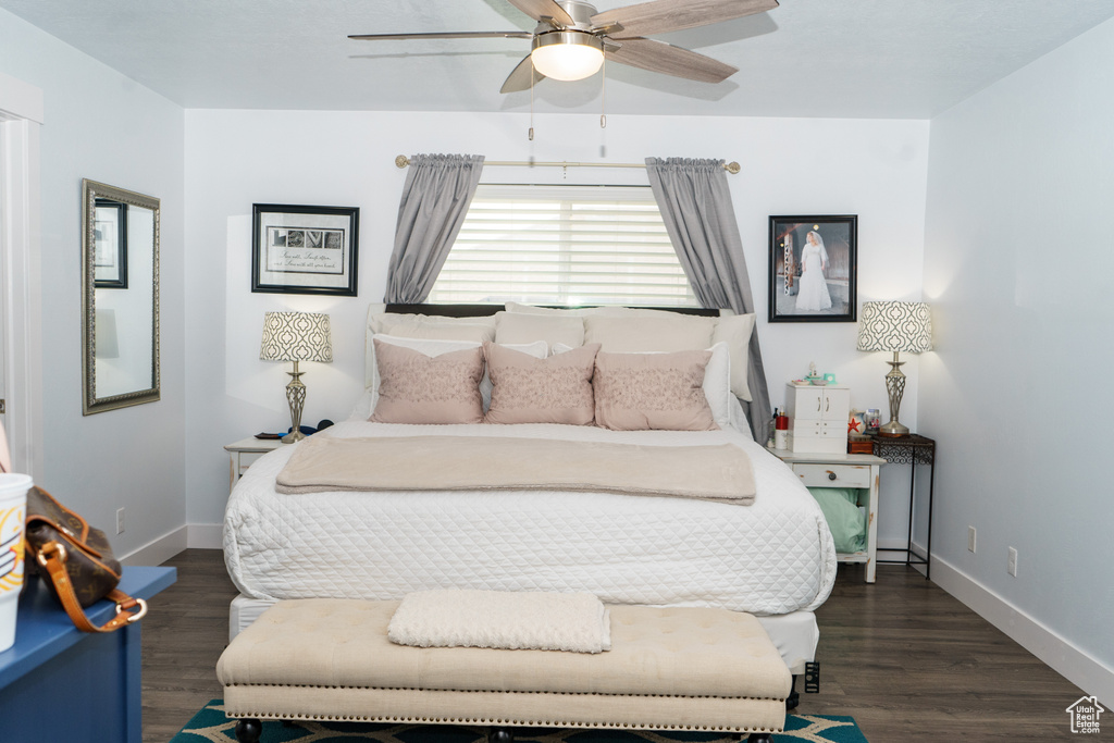 Bedroom with baseboards, wood finished floors, and ceiling fan