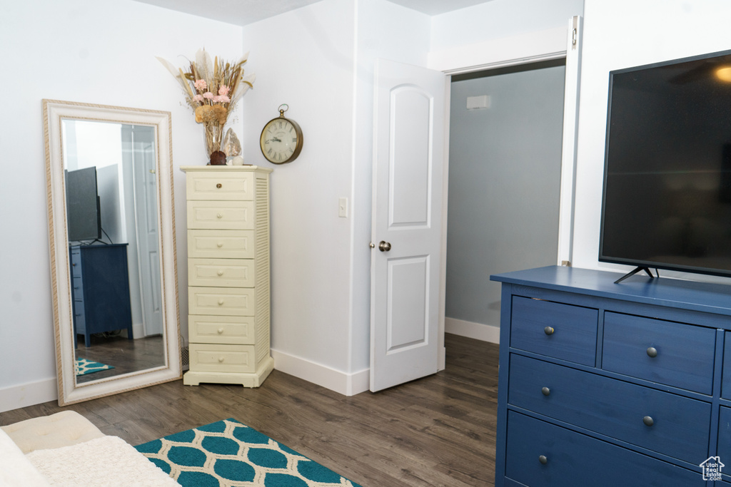 Bedroom featuring baseboards and dark wood-style floors