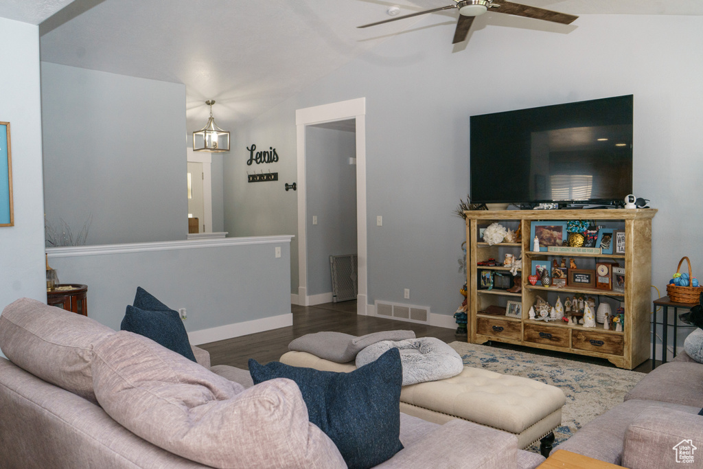 Living area with lofted ceiling, a ceiling fan, wood finished floors, and baseboards