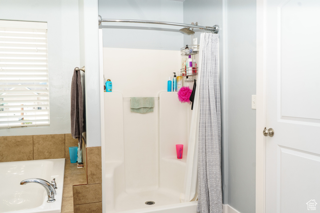 Full bath with a stall shower and a garden tub