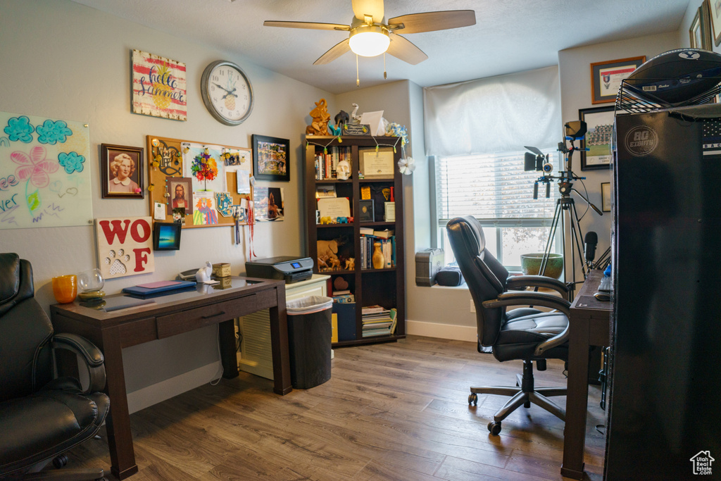 Office area featuring ceiling fan, wood finished floors, and baseboards