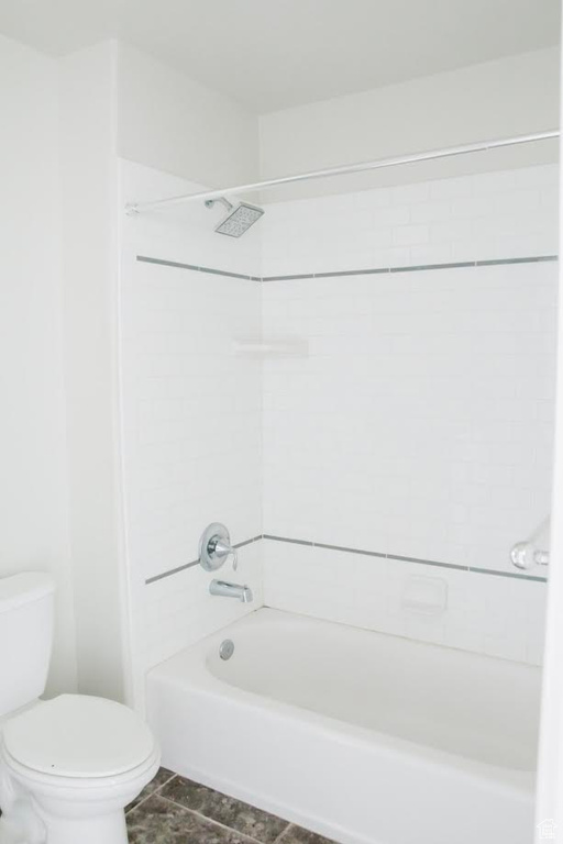 Bathroom with toilet, shower / bathtub combination, and tile patterned floors