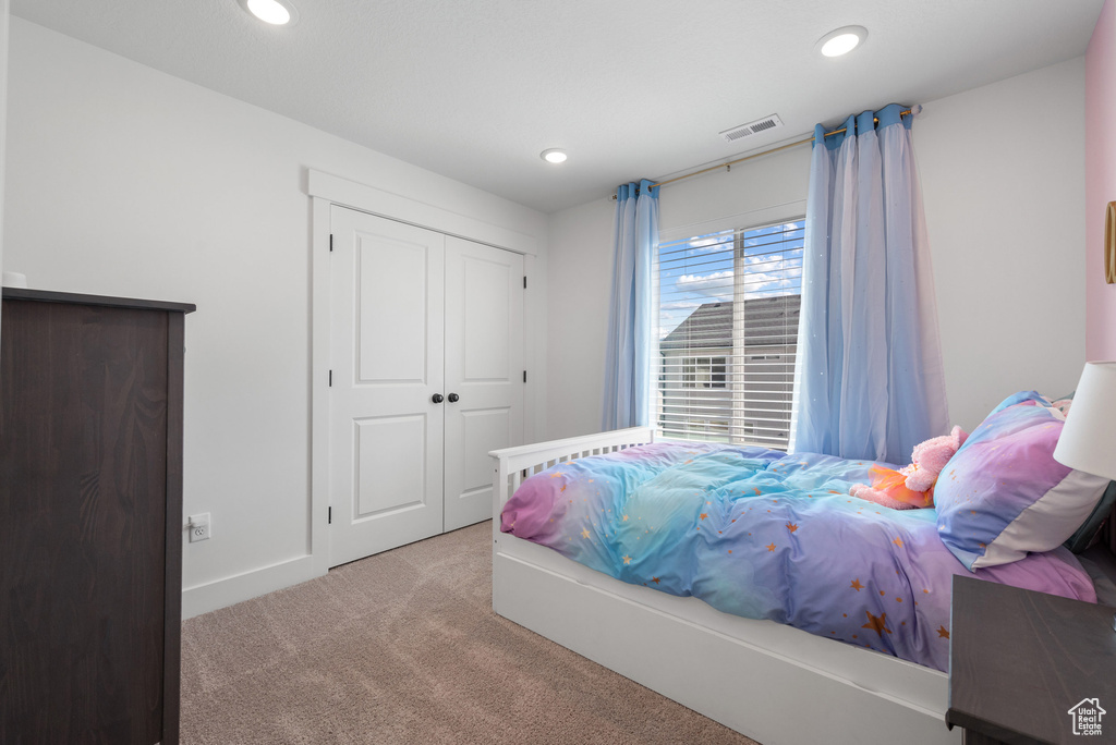 Carpeted bedroom featuring recessed lighting, a closet, and baseboards