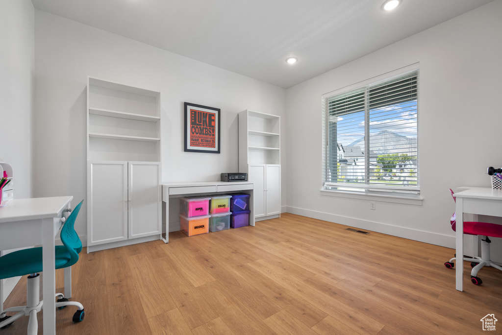 Home office with light wood-style floors, baseboards, and recessed lighting