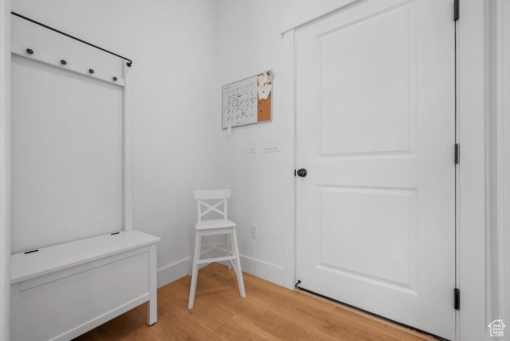 Mudroom with light wood-type flooring and baseboards
