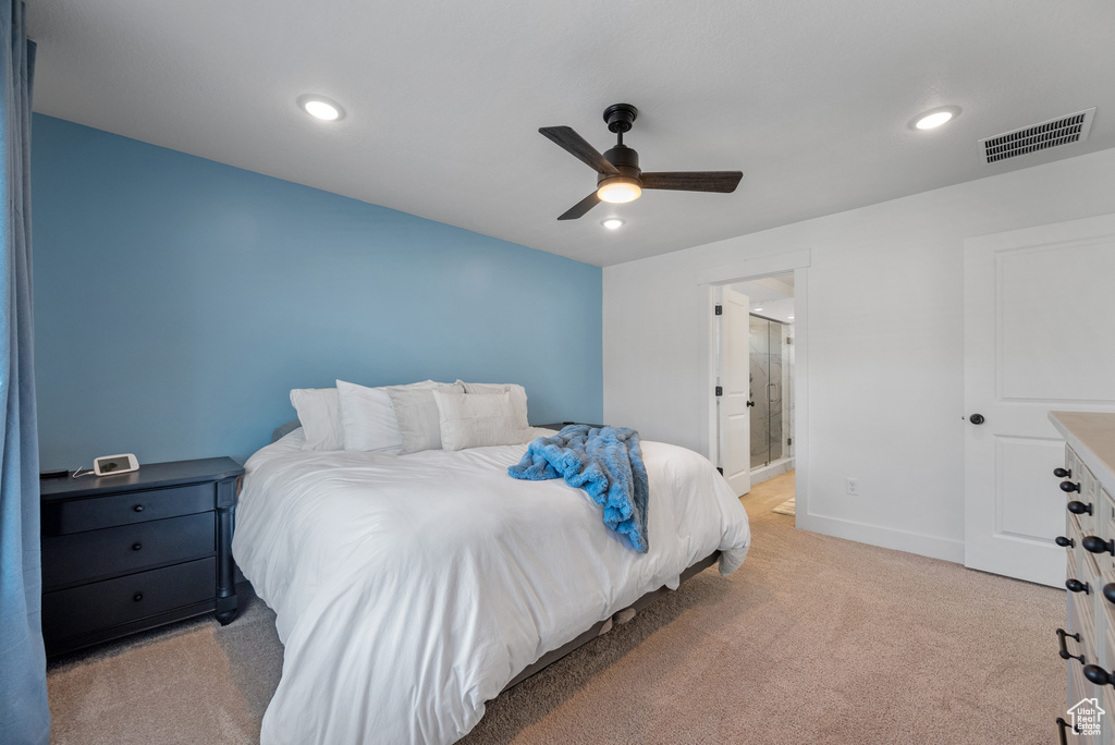 Bedroom featuring light carpet, baseboards, ceiling fan, recessed lighting, and ensuite bathroom