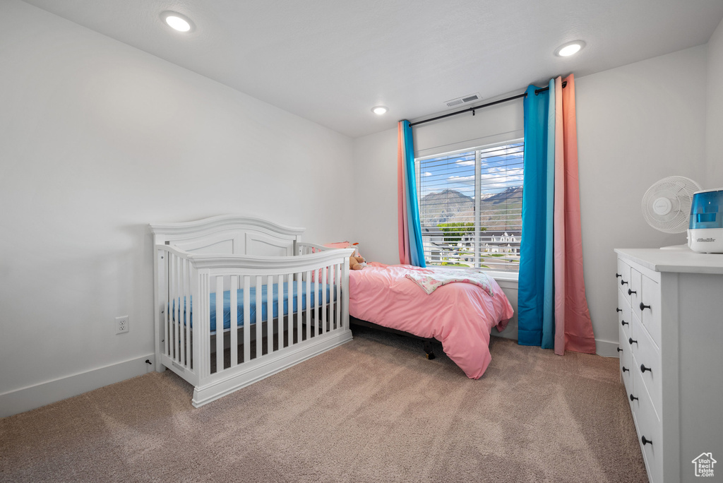 Carpeted bedroom with recessed lighting and baseboards