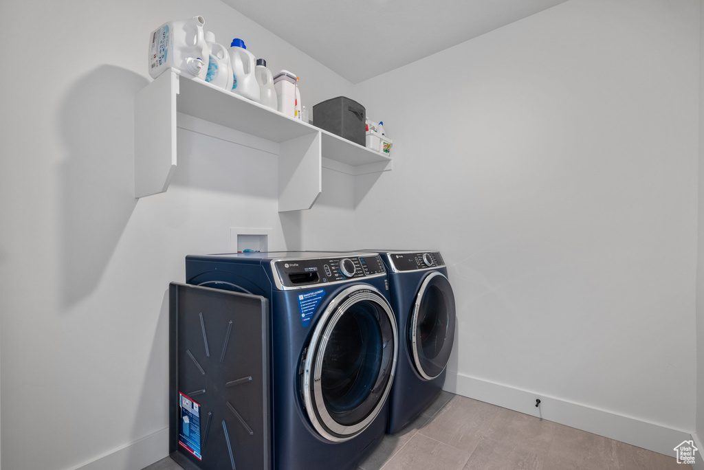 Laundry room featuring independent washer and dryer and baseboards
