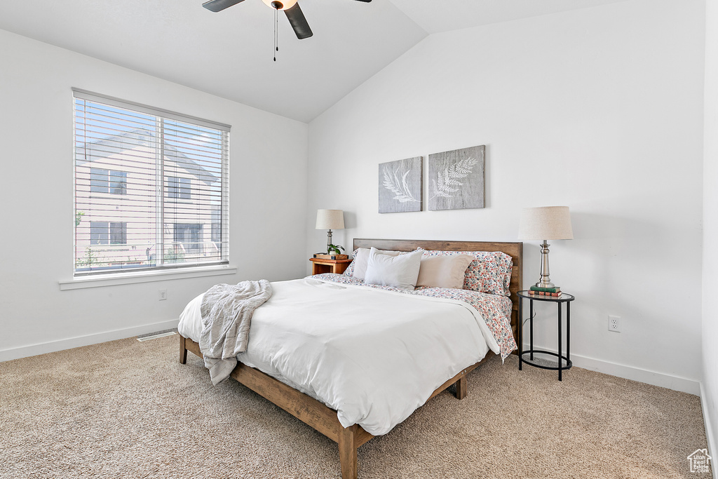 Bedroom with vaulted ceiling, baseboards, carpet, and ceiling fan