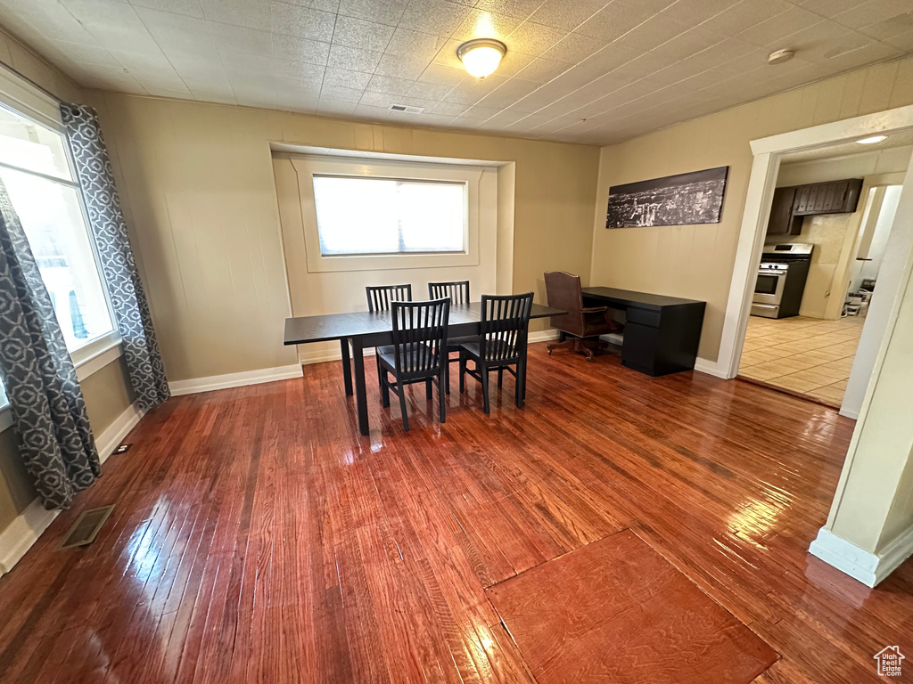 Dining area with hardwood / wood-style floors