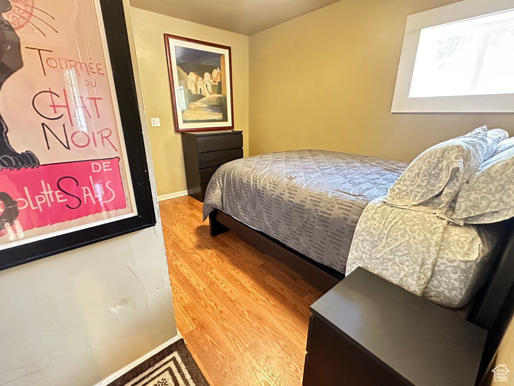 Bedroom featuring wood finished floors and baseboards