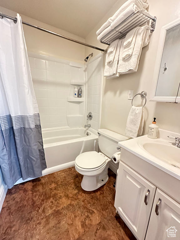 Bathroom with toilet, vanity, and shower / bathtub combination with curtain