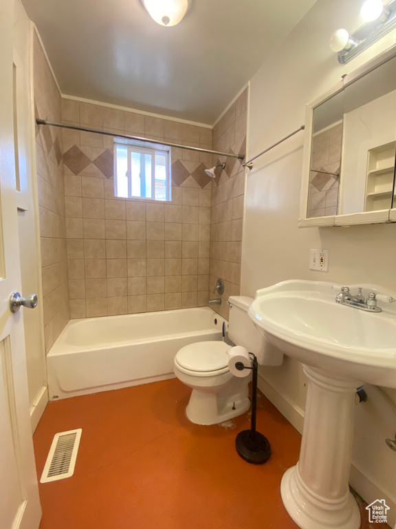 Full bath with bathing tub / shower combination, toilet, a sink, and baseboards