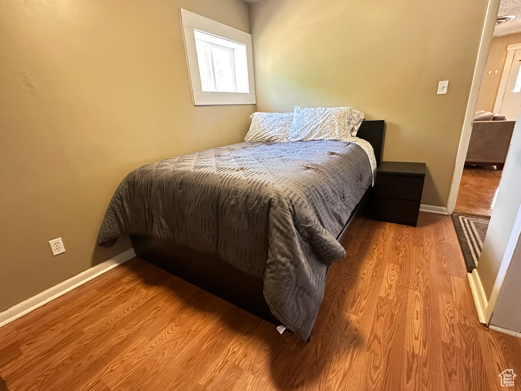 Bedroom featuring wood finished floors and baseboards