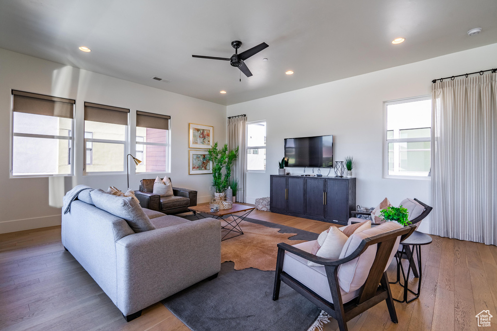 Living room with ceiling fan, wood-type flooring, recessed lighting, and baseboards