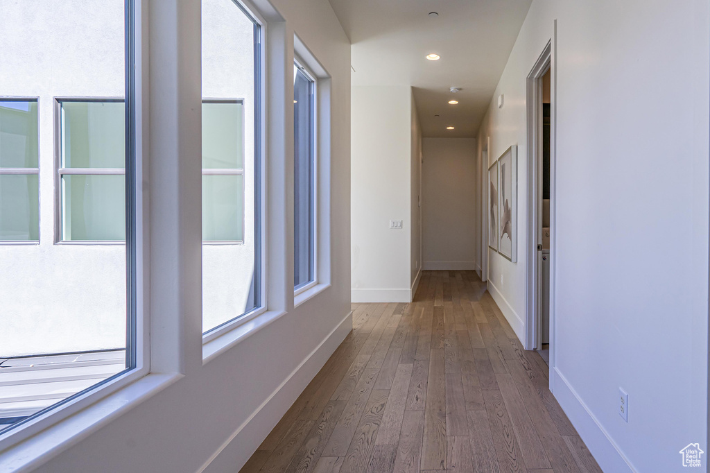 Hall featuring dark wood-style floors, recessed lighting, and baseboards