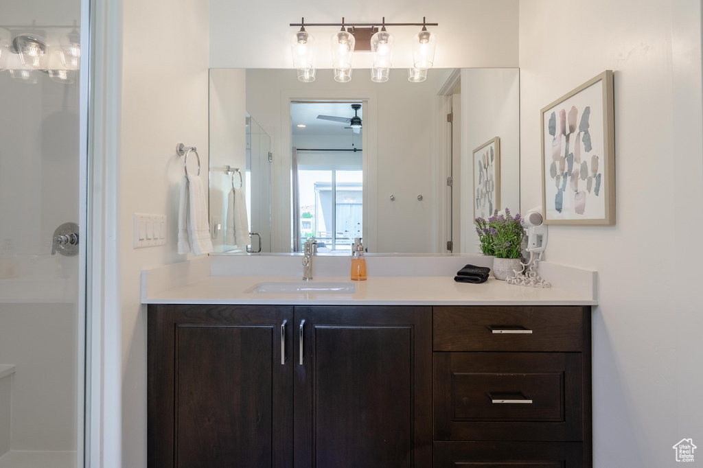 Bathroom featuring vanity, a shower stall, and ceiling fan