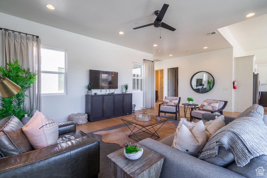 Living room featuring ceiling fan, wood finished floors, and recessed lighting
