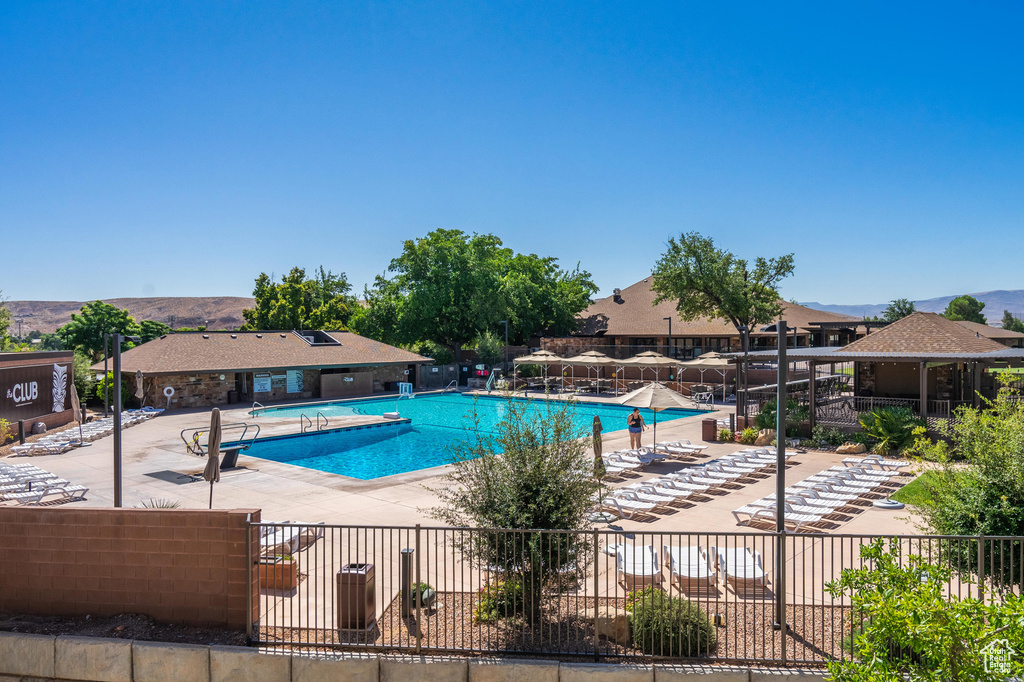 Community pool with a patio area and a mountain view