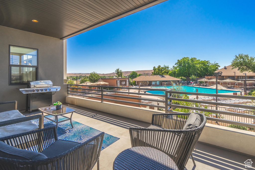 Balcony with view of pool area and grilling area