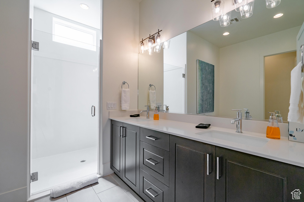 Full bathroom with double vanity, tile patterned flooring, a shower stall, and recessed lighting