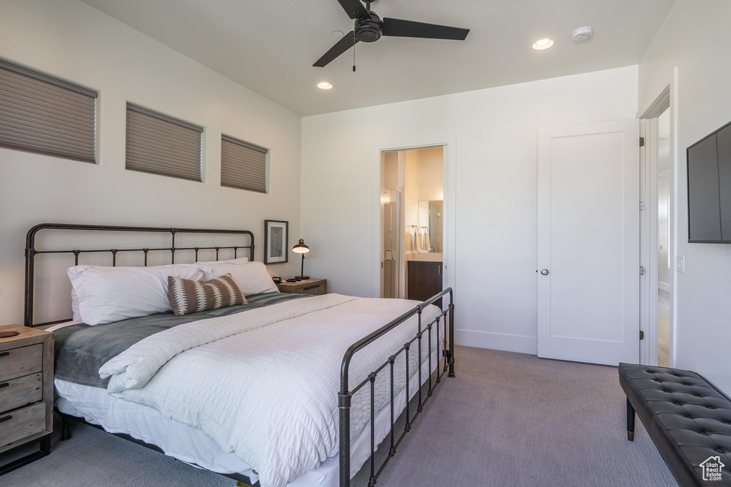 Carpeted bedroom featuring recessed lighting, ceiling fan, ensuite bath, and baseboards