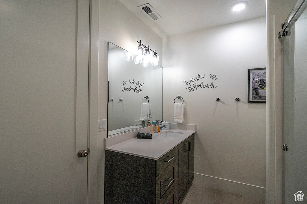 Bathroom featuring vanity, baseboards, recessed lighting, and tile patterned floors