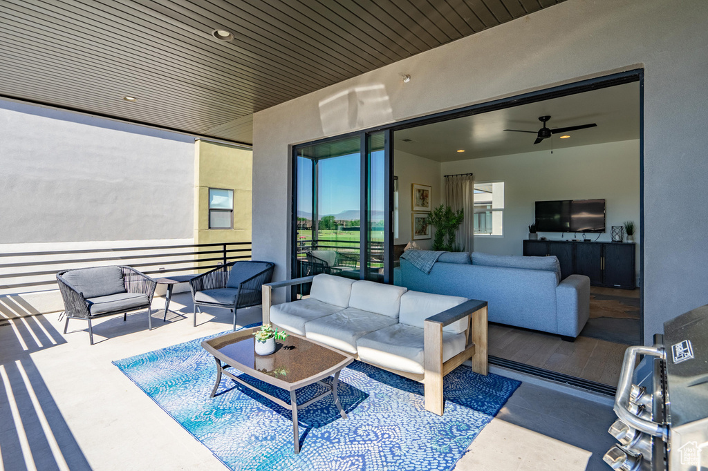 Living area featuring a ceiling fan and wooden ceiling