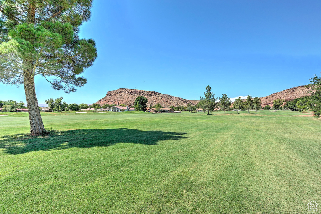 View of home's community with a mountain view and a lawn