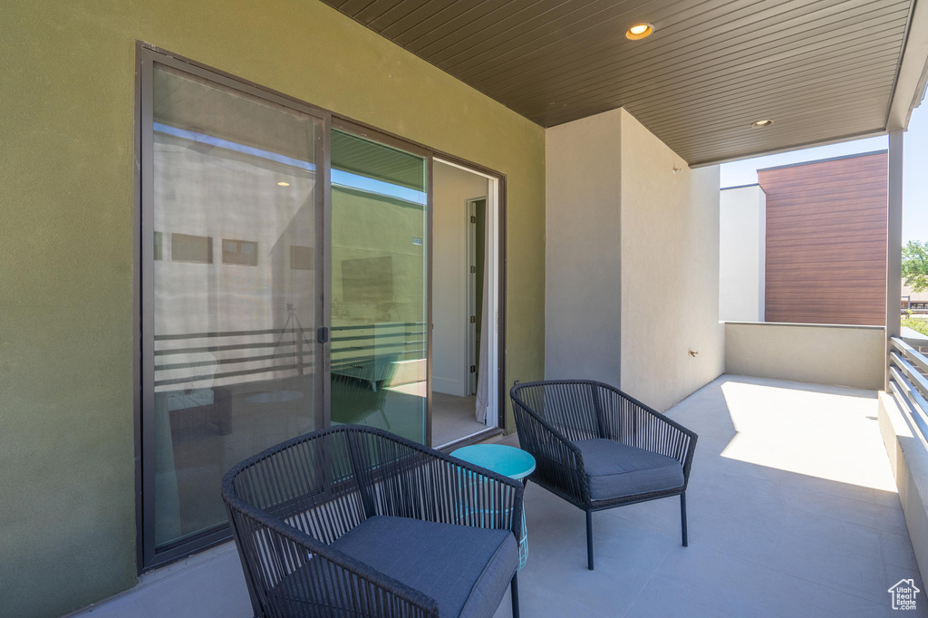 View of patio featuring a balcony