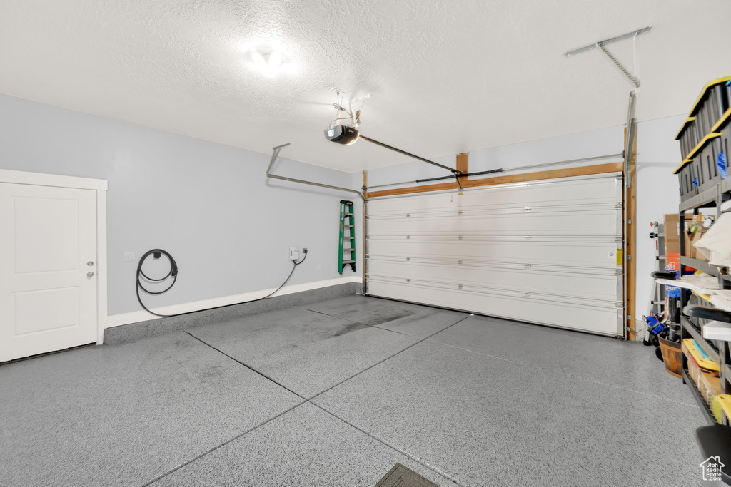 Garage featuring a garage door opener