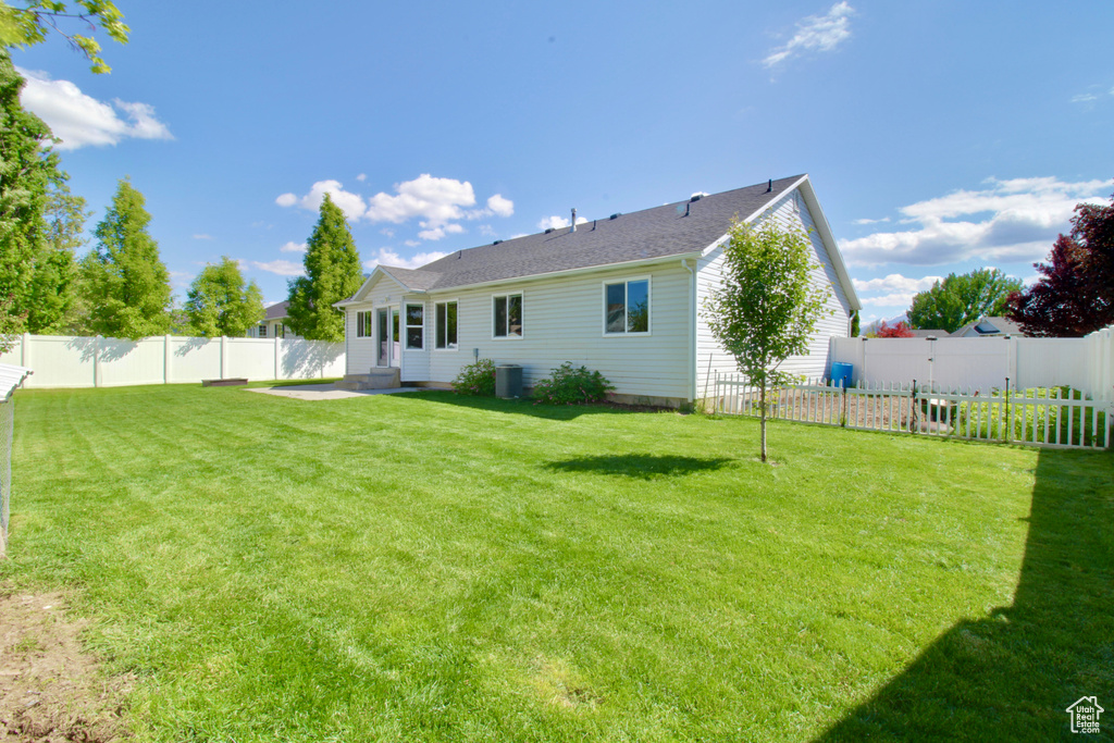 Rear view of property with a patio and central AC