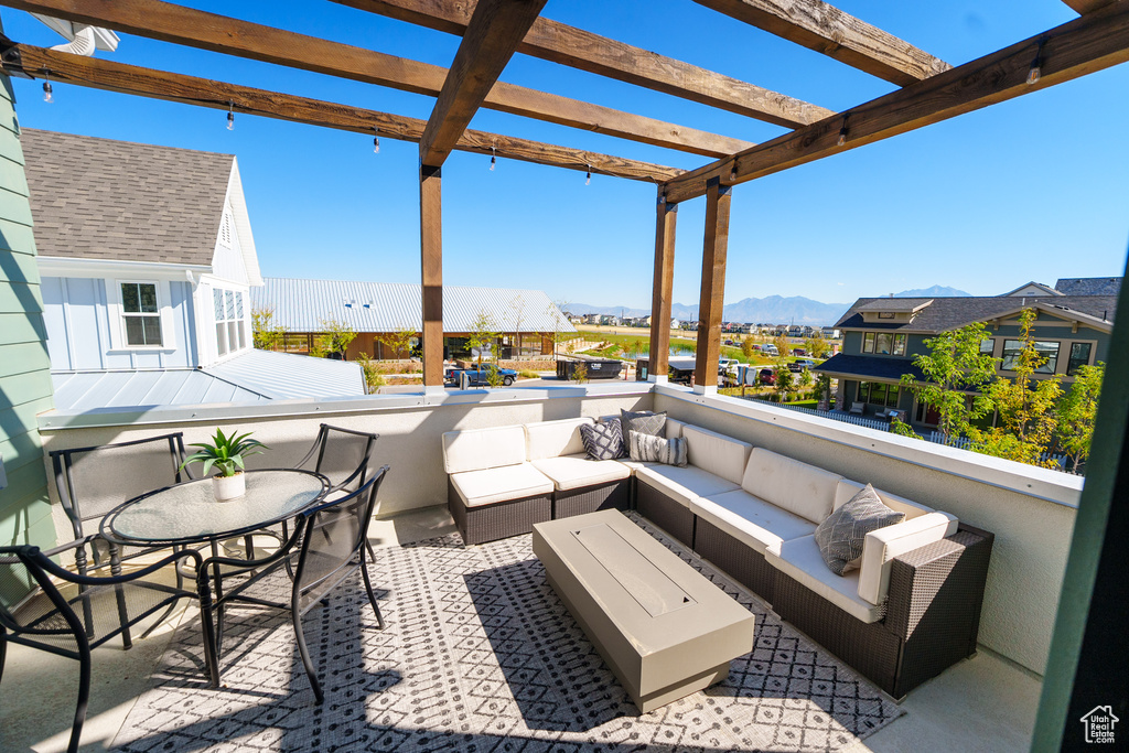 View of patio featuring an outdoor hangout area, a pergola, a mountain view, and a residential view