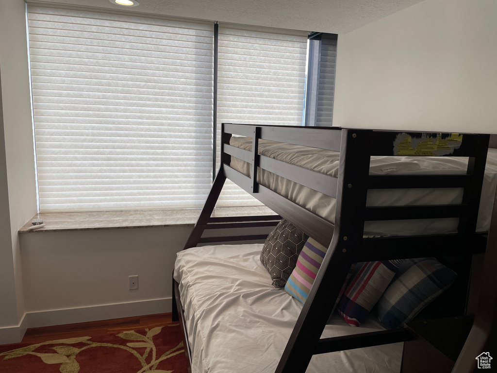 Bedroom with baseboards and wood finished floors