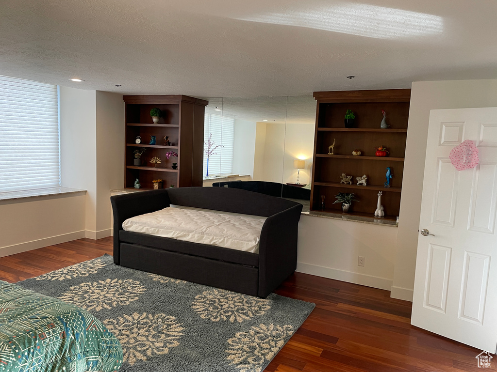Living area with wood finished floors and baseboards